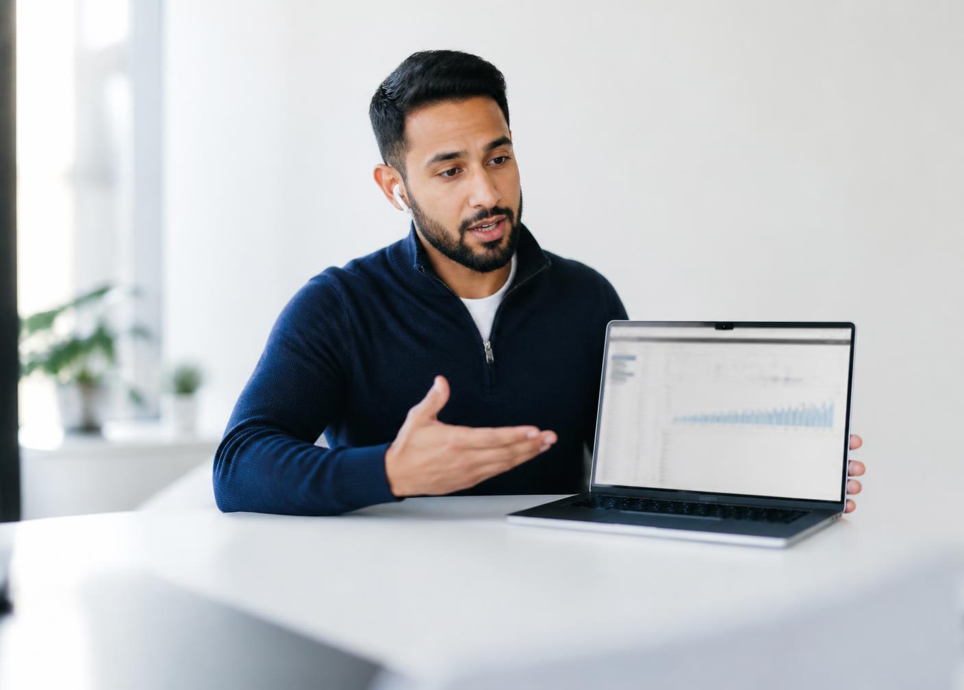 A pre-sales expert presenting a live software demo on a laptop